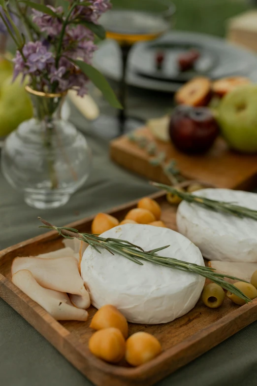 a close up of a plate of food on a table, renaissance, cheeses, modern rustic, centerpiece, harvest