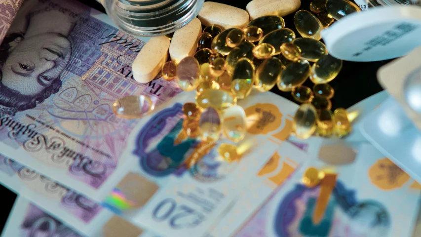 a bunch of pills sitting on top of a pile of money, by Alison Watt, renaissance, amethyst opal citrine, zoomed view of a banknote, thumbnail, high quality product image”