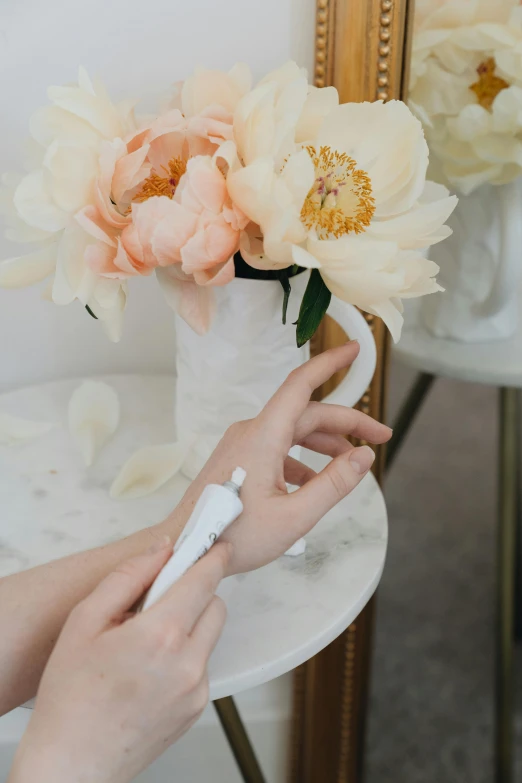 a woman holding a toothbrush in front of a vase of flowers, silicone skin, detailed product image, white petal, detail shot
