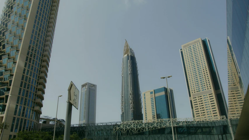 a bunch of tall buildings in a city, hurufiyya, in style of norman foster, exterior photo