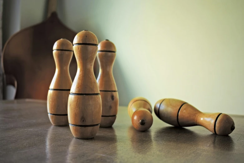 a group of wooden bowling pins sitting on top of a table, a still life, by Sylvia Wishart, unsplash, purism, mortar and pestle, curves, shot with sigma f/ 4.2, high resolution product photo