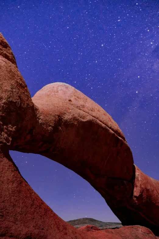 a rock formation with a star filled sky in the background, an abstract sculpture, by Peter Churcher, unsplash contest winner, big arches in the back, 4 k detail, slide show, samburu