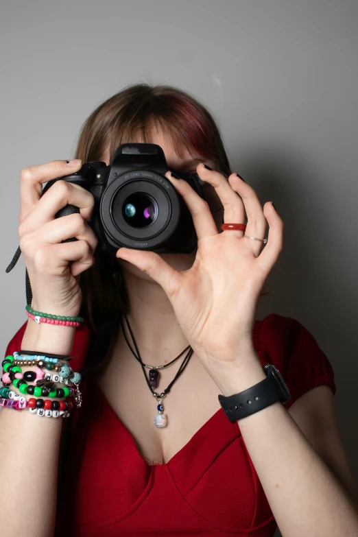 a woman taking a picture with a camera, inspired by Julia Pishtar, photo of a hand jewellery model, 1 / 4 headshot, front facing the camera, avatar image