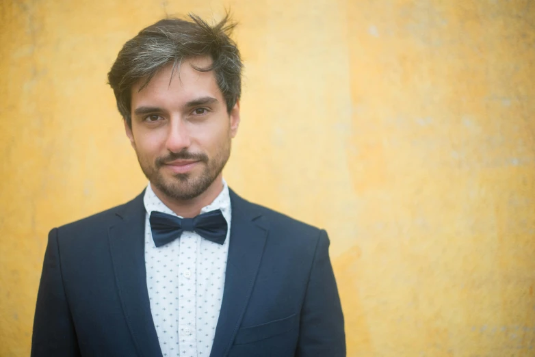 a man wearing a suit and bow tie, an album cover, inspired by Ramon Pichot, pexels contest winner, headshot profile picture, aged 2 5, casually dressed, thumbnail