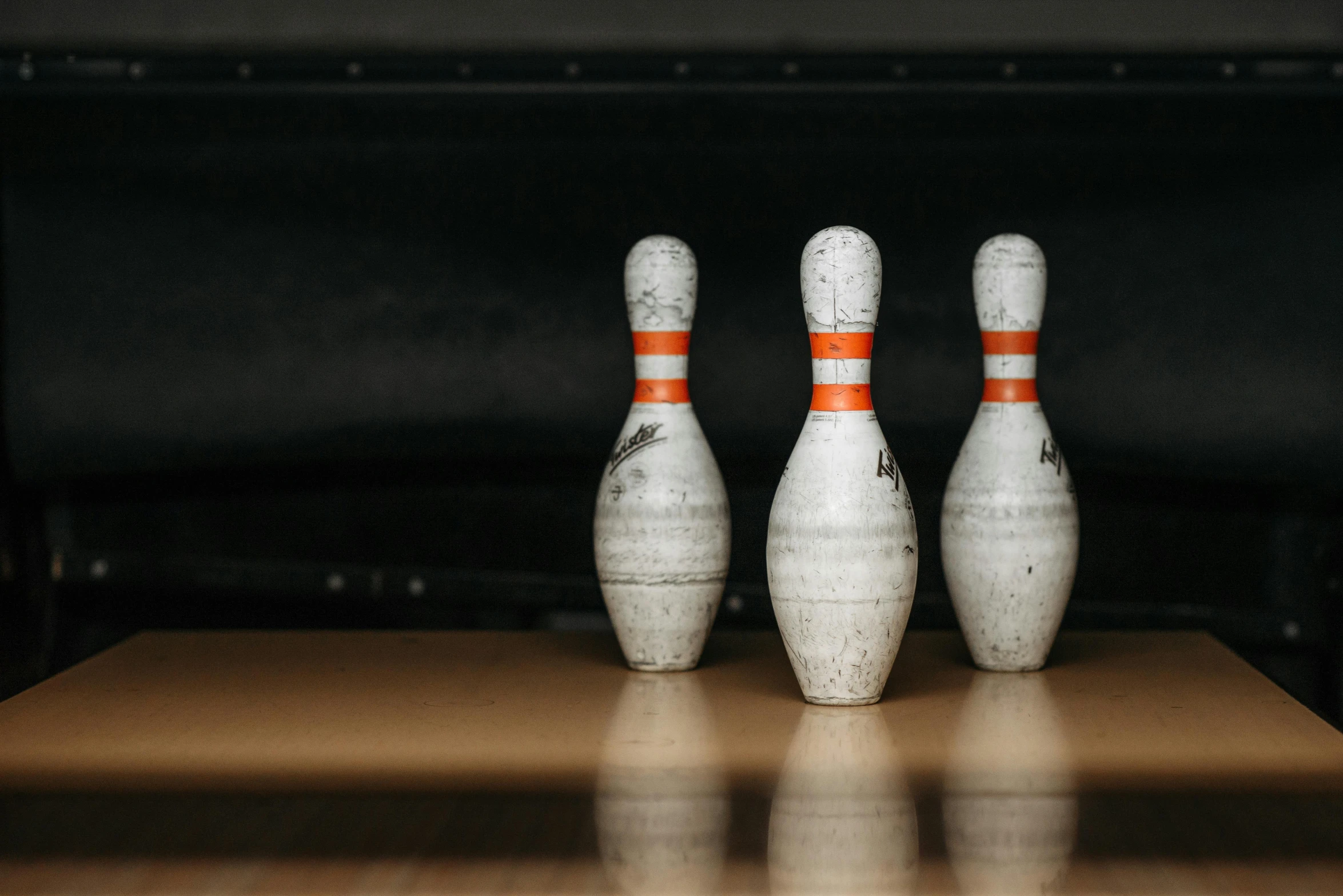 a row of bowling pins sitting on top of a wooden table