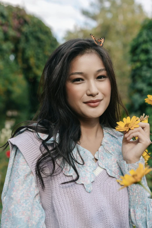 a woman holding a bunch of yellow flowers, an album cover, inspired by Ruth Jên, trending on pexels, sumatraism, beautiful young himalayan woman, in autumn, icon, 🍁 cute