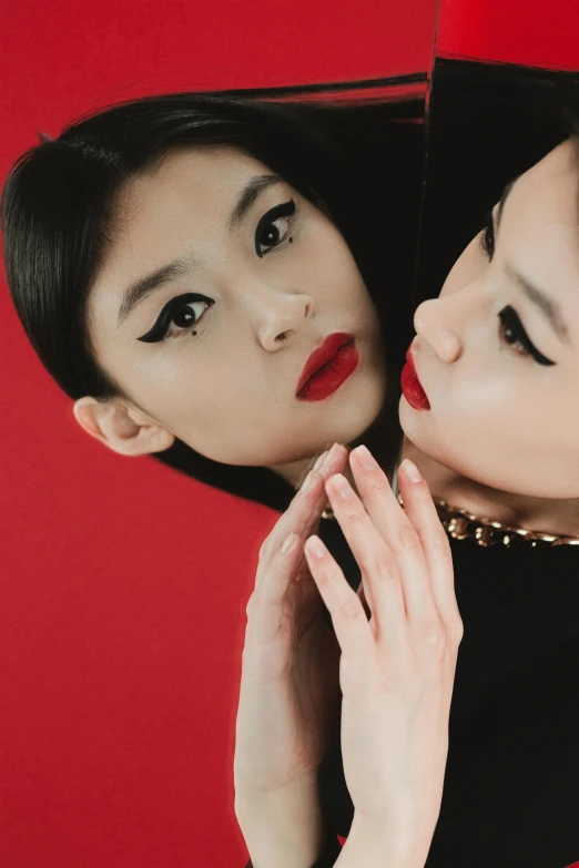 a couple of women standing next to each other, an album cover, inspired by Wang Duo, trending on pexels, red contact lenses, korean audrey hepburn, gemma chan girl portrait, red and black colors