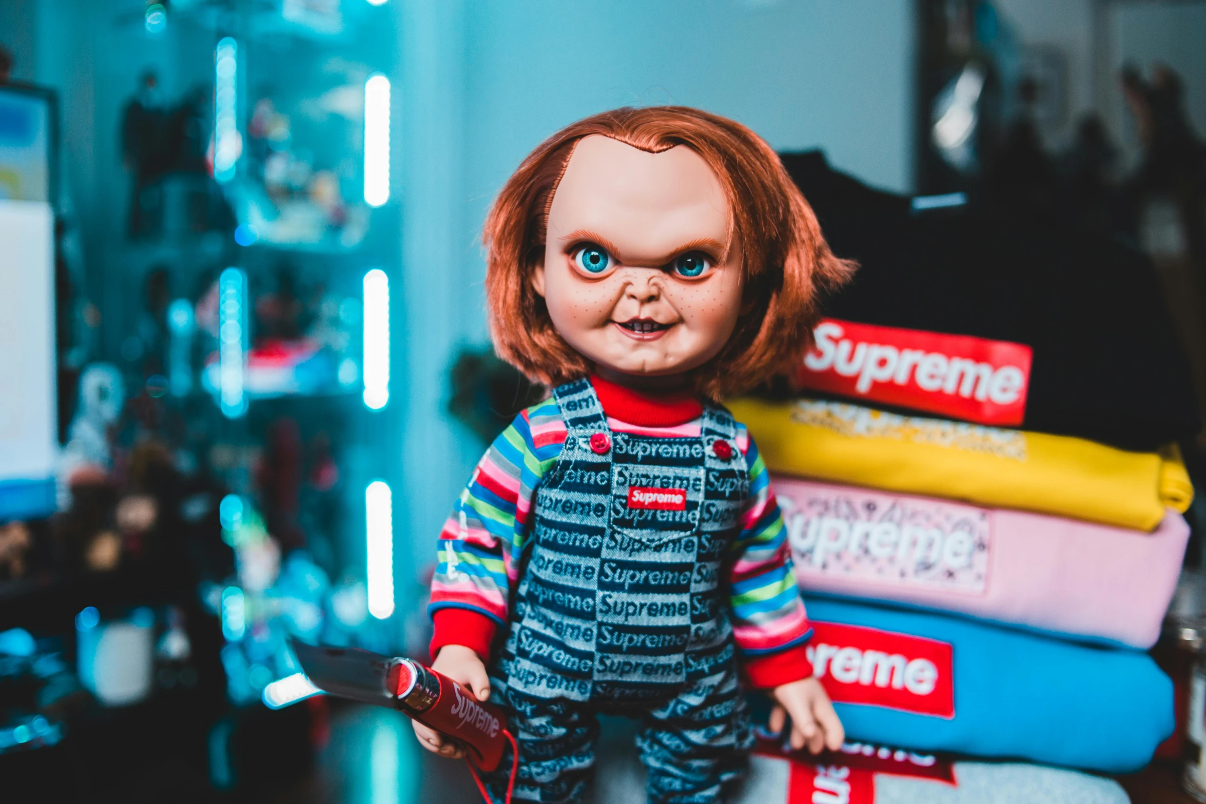 a doll sitting on top of a pile of books, trending on pexels, lowbrow, hannibal lector, chucky, movie still of a snarling, butcher billy