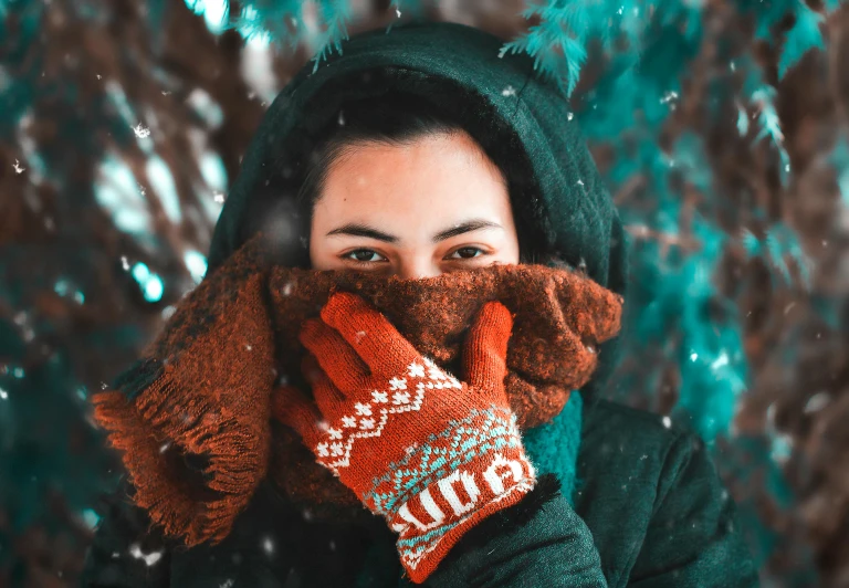 a woman covering her face with a pair of mittens, pexels contest winner, avatar image, orange and teal color, girl with brown hair, 🦩🪐🐞👩🏻🦳