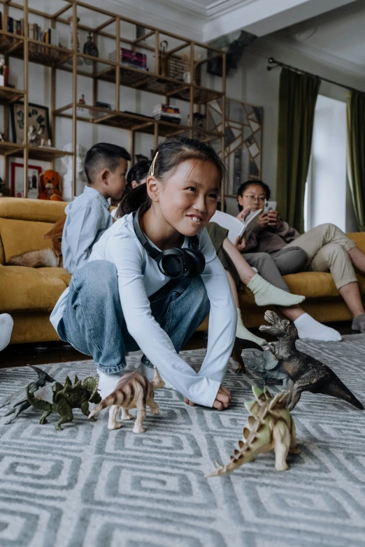 a woman sitting on the floor playing with a cat, dinosaurs, teenager hangout spot, as action figures, families playing
