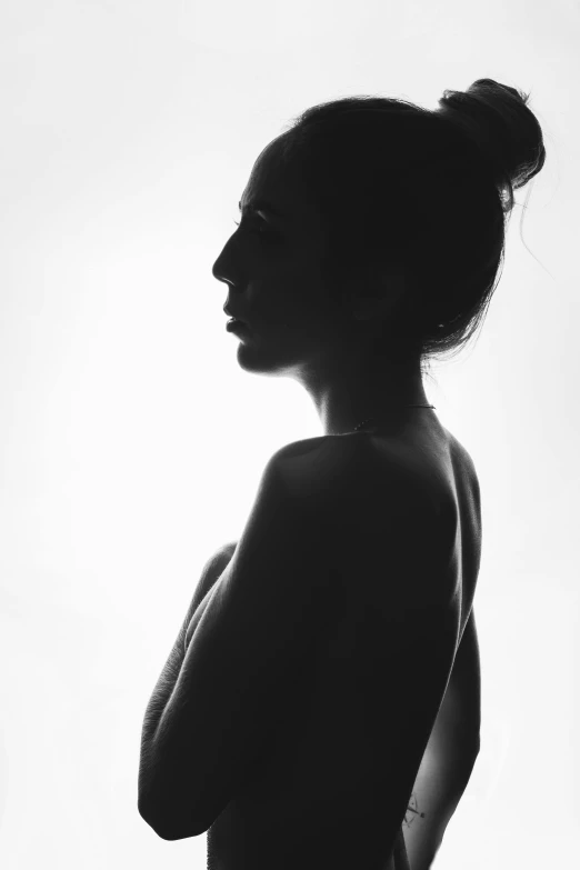 a black and white photo of a naked woman, a black and white photo, by Clifford Ross, unsplash, woman's profile, silhouette :7, medium portrait top light, actual photo