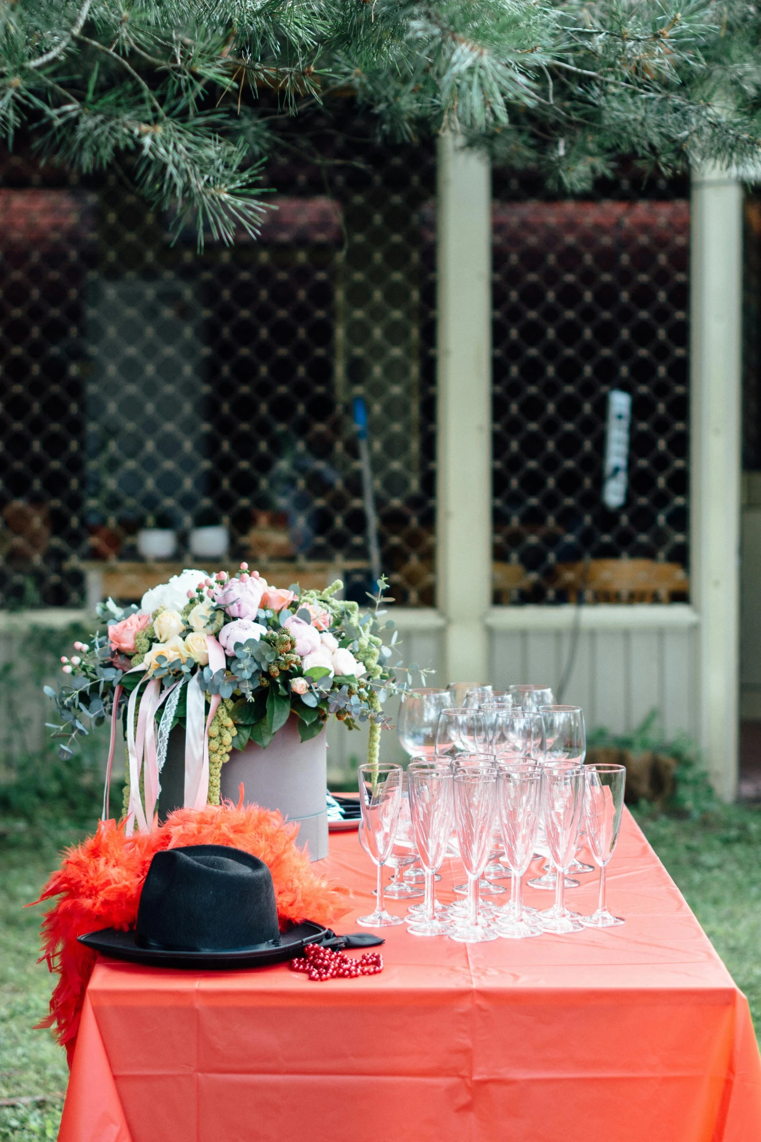 a table that has a hat and glasses on it, unsplash, romanticism, party in front, covered outdoor stage, bouquets, high resolution photo