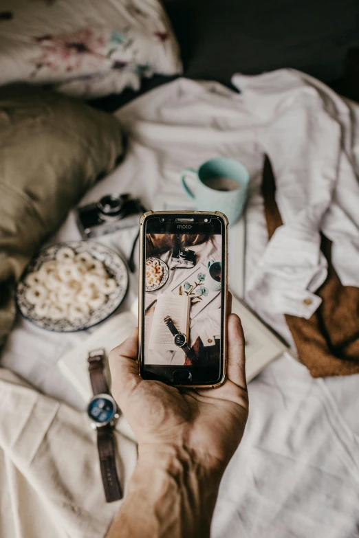 a person taking a picture of food on a bed, a picture, trending on pexels, happening, moody details, old photo scattered, in love selfie, flatlay