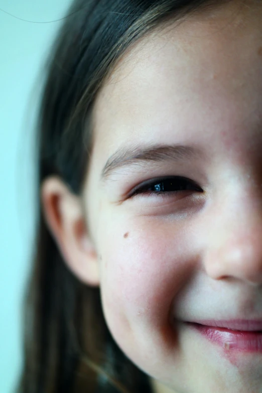 a close up of a young girl smiling at the camera, incoherents, winking one eye, scientific photo, zoomed in