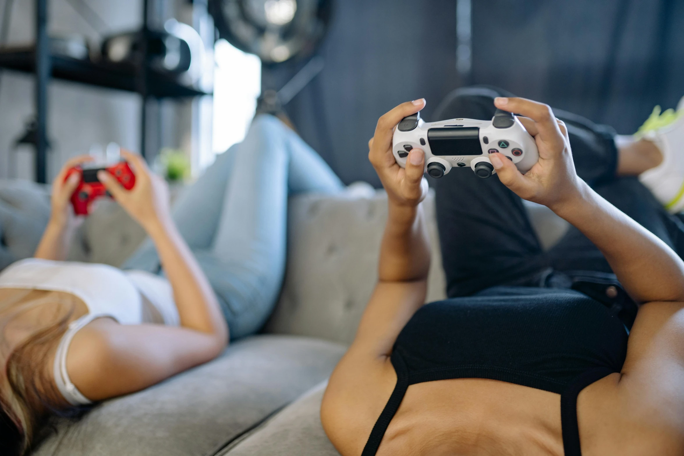 two women laying on a couch playing a video game, trending on pexels, first playstation graphics, body shot, portal game 9 4 4 9 9 valve, mid body shot