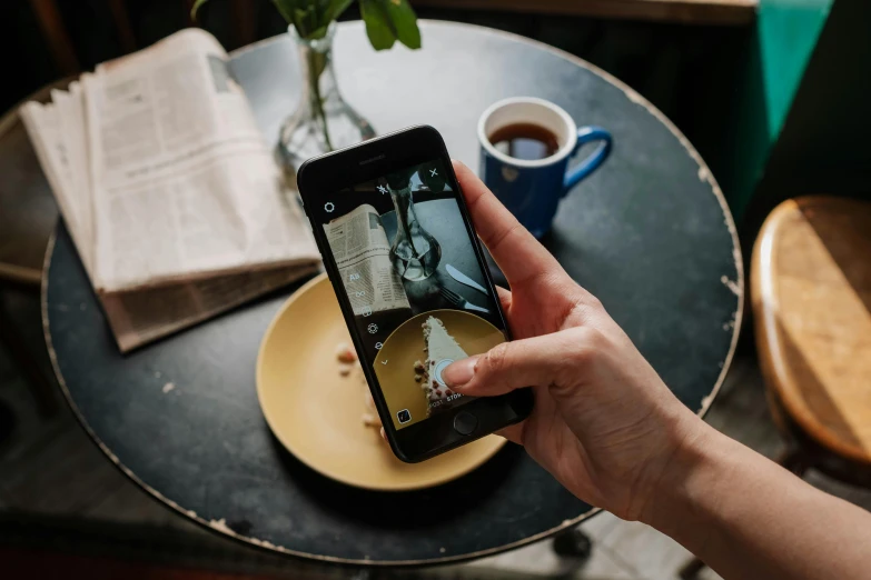 a person taking a picture of a plate of food, by Matthias Stom, trending on unsplash, on a coffee table, scratched photo, instagram story, stop motion animation