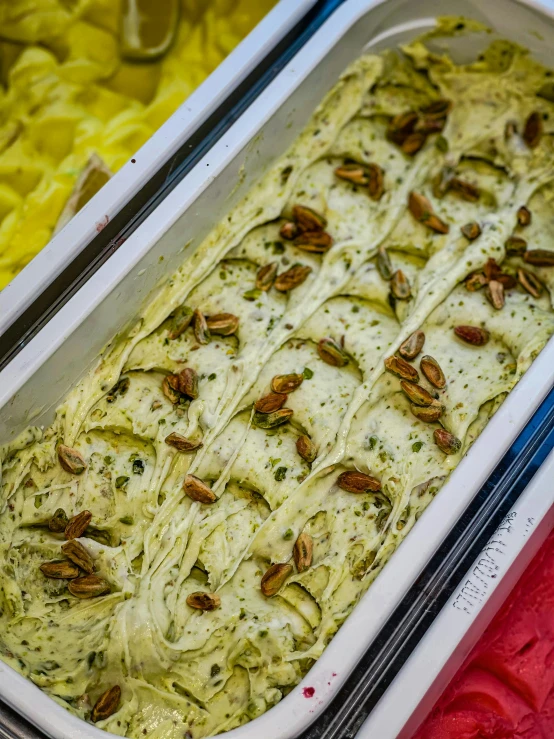 a close up of two pans of food on a table, ice cream, with an intricate, seeds, lynn skordal