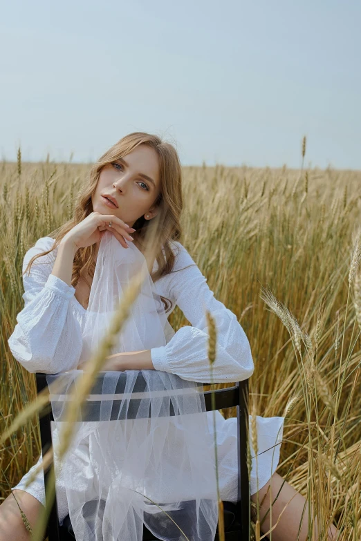 a woman sitting in a field of tall grass, inspired by Apollinary Vasnetsov, trending on pexels, white clothing, sitting on a chair, photoshoot for skincare brand, rectangle