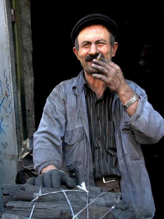 a man smoking a cigarette in front of a building, by Mahmoud Farshchian, pexels contest winner, arbeitsrat für kunst, female blacksmith, a still of a happy, bosnian, made of cement