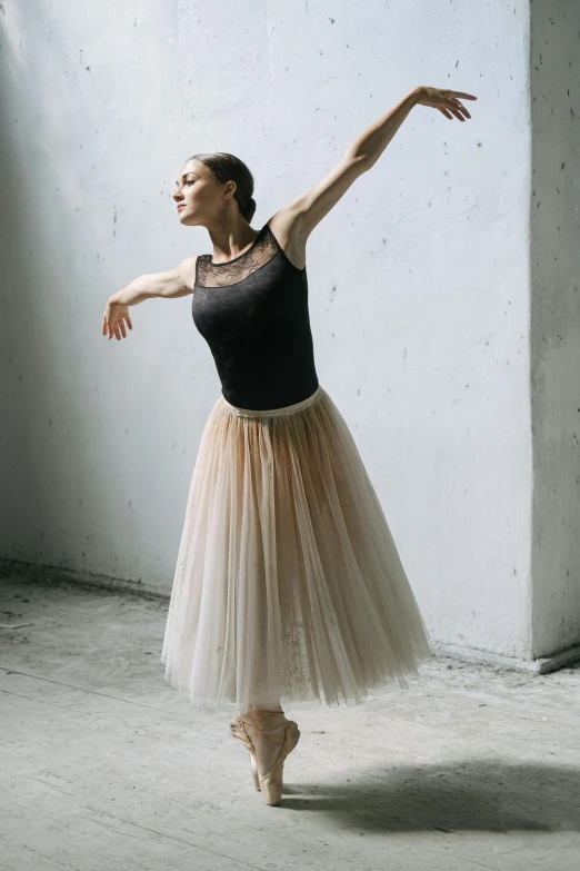 a woman that is standing in a room, by Elizabeth Polunin, arabesque, long skirt, wearing a tutu, on grey background, 奈良美智