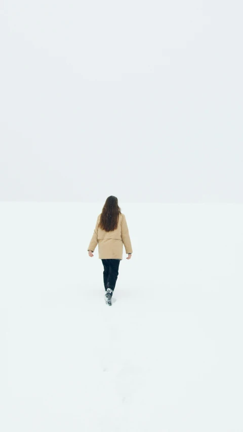 a woman walking across a snow covered field, minimalism, white floor, 6 k, instagram photo, filmstill