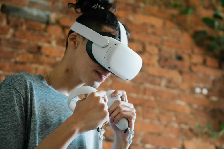 a woman holding a video game controller in front of a brick wall, an ambient occlusion render, trending on pexels, interactive art, vr helmet on man, studying a hell open rift portal, goggles on forehead, top-down shot