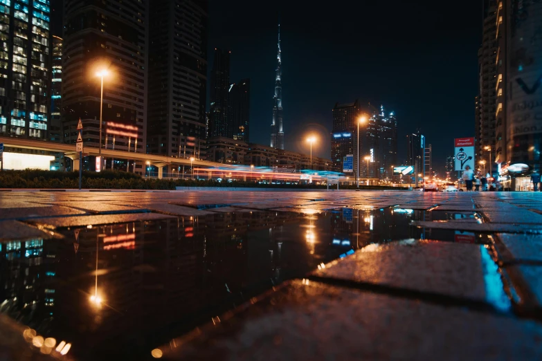 a puddle of water on a city street at night, pexels contest winner, gta : dubai, fan favorite, thumbnail, lightweight