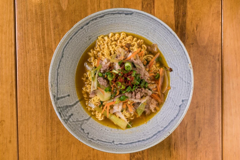 a bowl of food sitting on top of a wooden table, a picture, ramen, square, thumbnail, birdseye view