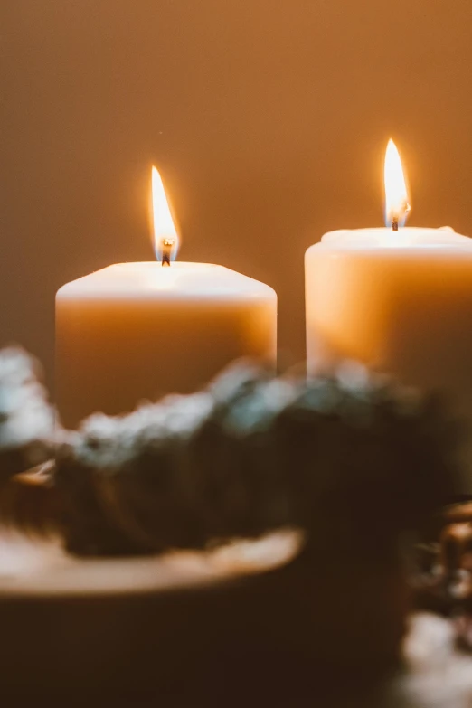 three lit candles sitting on top of a table, by Jesper Knudsen, trending on unsplash, half image, soft warm light, holiday, grieving