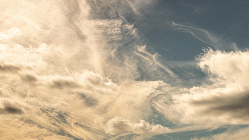 a man flying a kite on top of a lush green field, inspired by George Frederic Watts, unsplash, romanticism, layered stratocumulus clouds, in muted colours, evening sun, cloud nebula