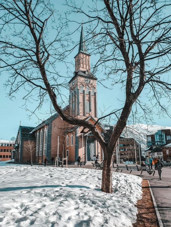 a church on a snowy day with a tree in the foreground, by Julia Pishtar, pexels contest winner, vancouver school, 🚿🗝📝, bright sunny day, buildings covered in black tar, designed for cozy aesthetics!