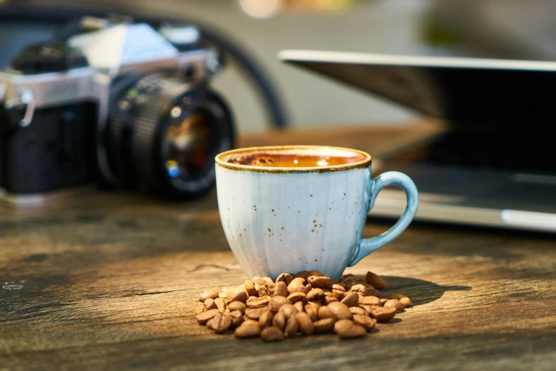 a cup of coffee sitting on top of a wooden table, a still life, inspired by Peter de Sève, trending on pexels, hasselblad film bokeh, ground - level medium shot, 8 k octane comprehensive render, copper cup