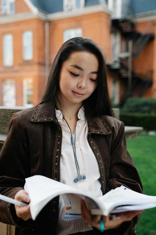 a woman sitting on a bench reading a book, inspired by Feng Zhu, wearing jacket, post graduate, holding notebook, profile image