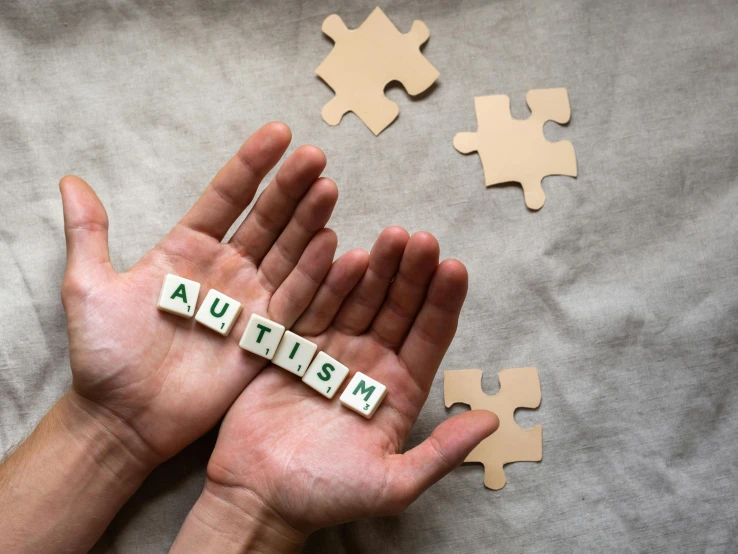 a person holding a puzzle piece with the word autism spelled on it, by Julia Pishtar, trending on pexels, antipodeans, square, set pieces, stable diffusion ai as a human, children's