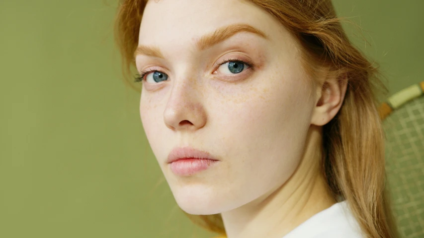 a close up of a woman with freckles on her face, inspired by Lucian Freud, trending on pexels, sadie sink, light green tone beautiful face, photoshoot for skincare brand, eva elfie