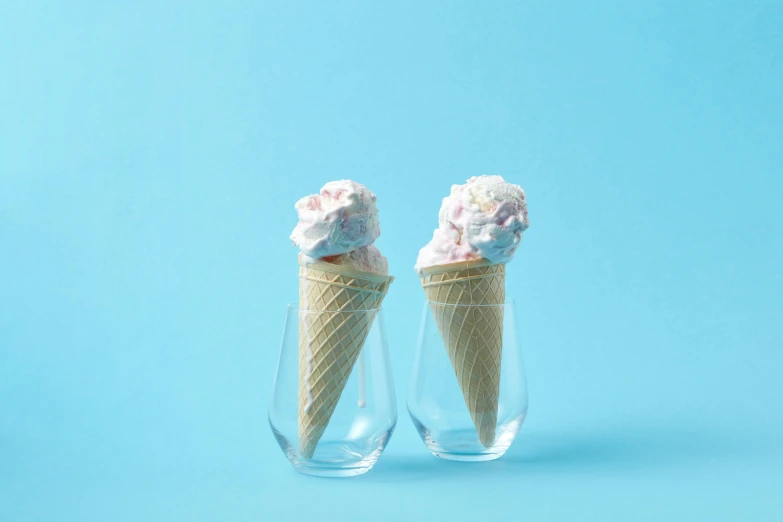 two ice cream cones in a glass on a blue background, unsplash, featuring pink brains, white background and fill, epicurious, angled