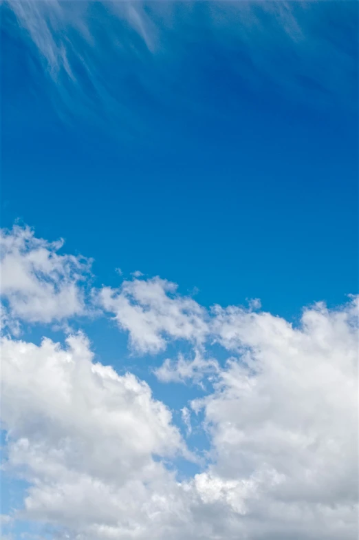 a man flying a kite on top of a lush green field, unsplash, minimalism, layered stratocumulus clouds, vibrant blue, today\'s featured photograph 4k, cumulus