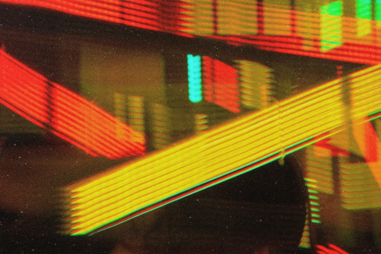 a pair of scissors sitting on top of a table, an album cover, inspired by Elsa Bleda, computer art, databending, red and yellow light, close up 1 9 9 0, lines of lights