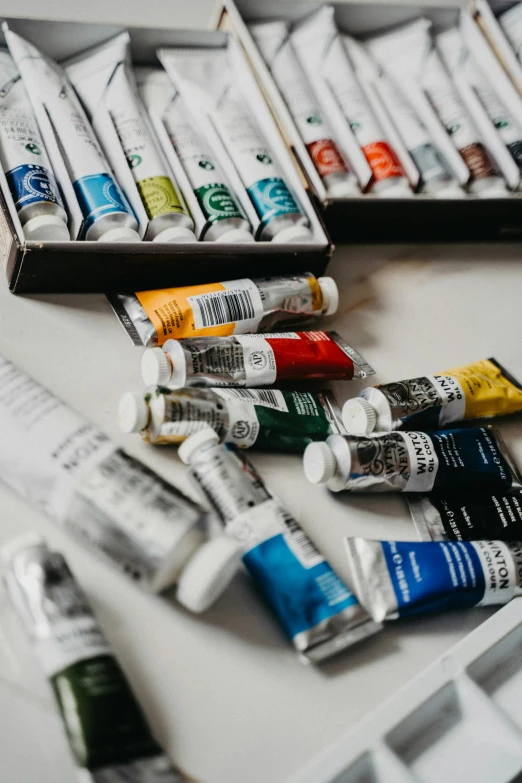 a box of paint sitting on top of a table, pexels contest winner, academic art, tubes, afremov, white wall coloured workshop, oil on canvas high angle view