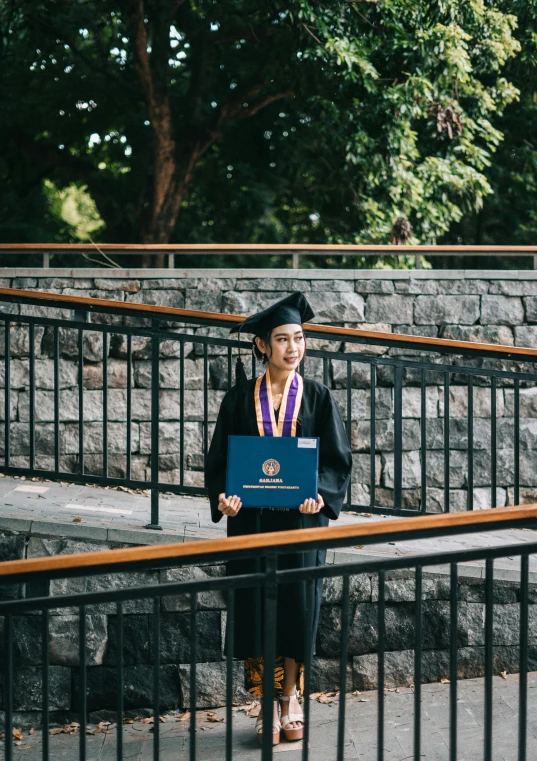 a woman in a graduation gown holding a diploma, a portrait, unsplash, thawan duchanee, garbed in a purple gown, wandering, private academy entrance