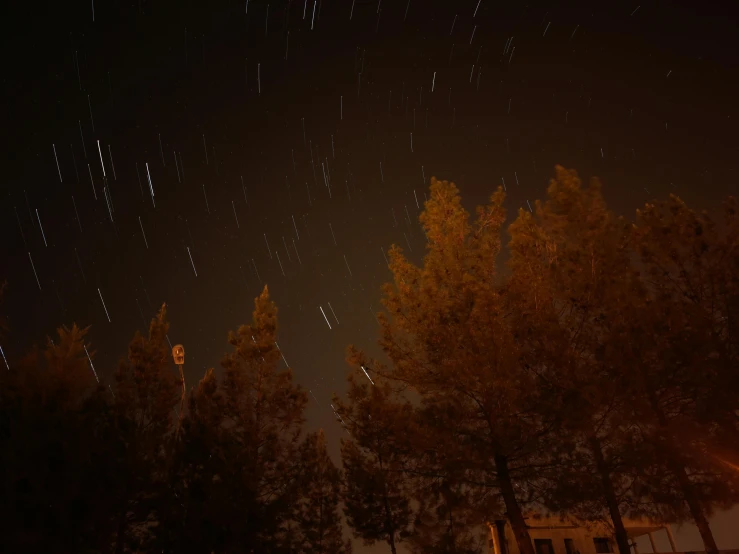 a night sky filled with lots of stars, a picture, unsplash, realism, thunderstorm in marrakech, scary pines, tracingstar trails, autumn night