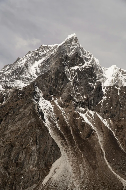 a man riding a snowboard on top of a snow covered mountain, seen from a distance, nepal, high res 8k, limestone