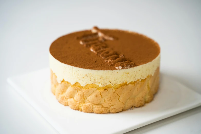 a cake sitting on top of a white plate, murata range, gold and white, bakery, detailed product image