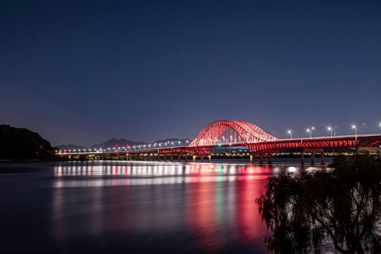 a red bridge over a body of water at night, by Jang Seung-eop, pexels contest winner, pyongyang city, chile, fine art print, high quality picture