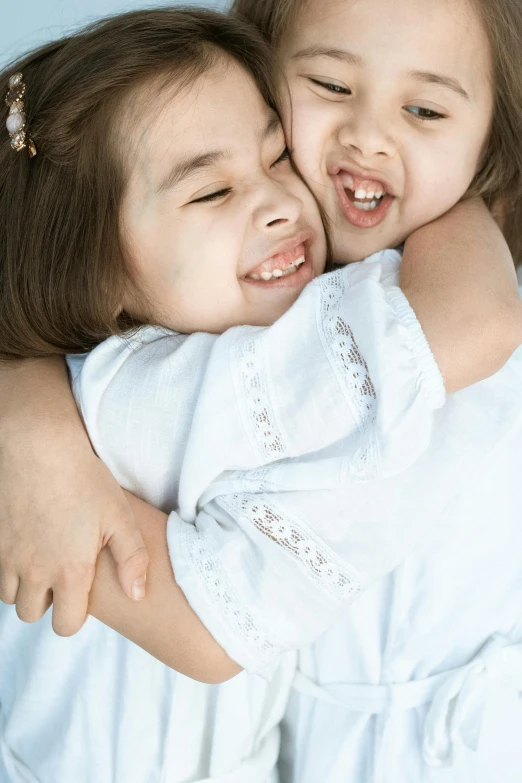 a couple of little girls hugging each other, pexels contest winner, incoherents, super detailed image, soft lulling tongue, product shot, full product shot