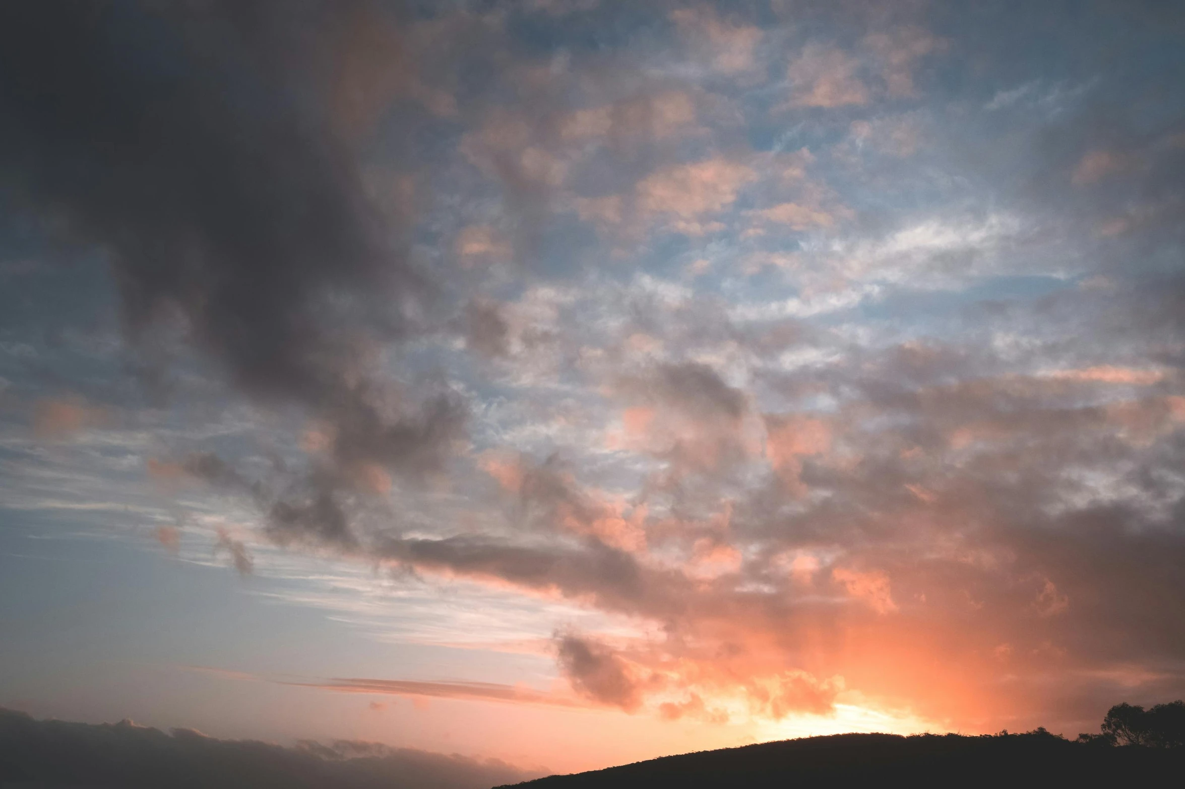 a couple of cows standing on top of a lush green field, by Julian Hatton, unsplash, romanticism, hazy sunset with dramatic clouds, over the hills, redpink sunset, timelapse