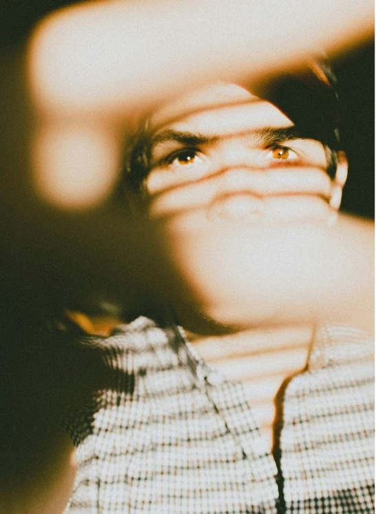 a close up of a person holding a cell phone, a picture, inspired by Elsa Bleda, symmetrical face orelsan, his eyes glowing yellow, profile image, overexposed photograph