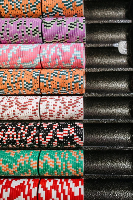 a bunch of different colored bracelets stacked on top of each other, by Carey Morris, kinetic pointillism, world series of poker, conveyor belts, 2 5 6 x 2 5 6 pixels, photo taken from above