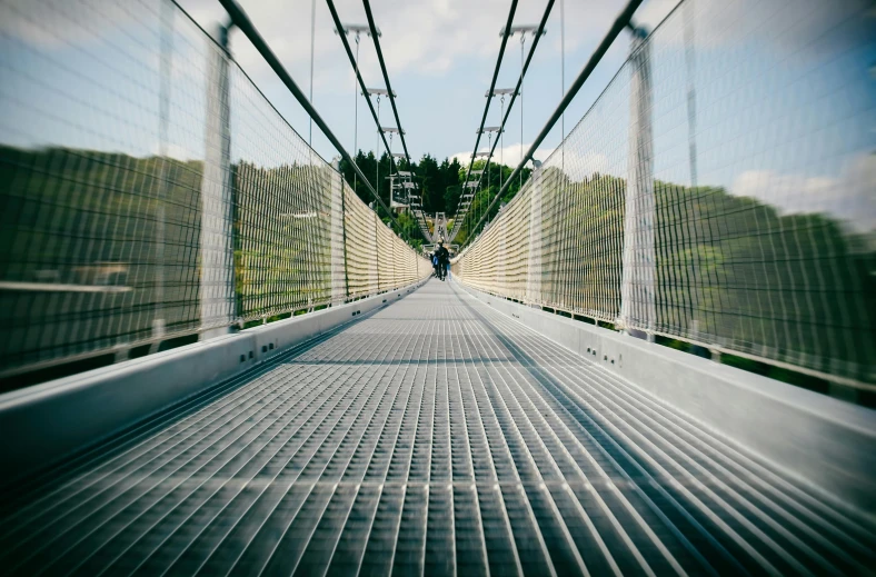 a view from the bottom of a suspension bridge, pexels contest winner, walking towards camera, panels, subtle detailing, white