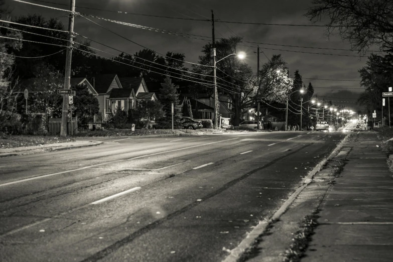 a black and white photo of a street at night, inspired by Gregory Crewdson, unsplash, suburbs, clean streets, suburb, journalism photo